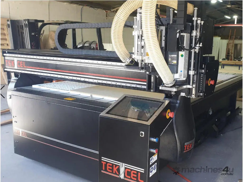 Large-format Tekcel CNC router machine for precision cutting of metal, acrylic, and wood signage materials.