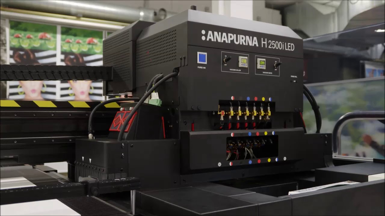 Anapurna H2500i LED UV flatbed printer producing high-resolution prints on rigid materials.